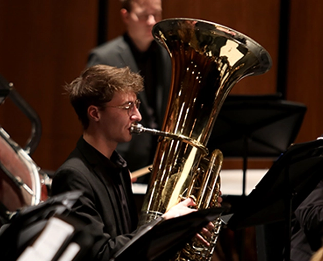 Student playing a tuba