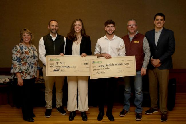 Alexandria Arndt, center left, and Sam Tremelling, center right, were presented with $500 checks for their winning ideas at Northerns Idea Pitch Competition. The judges were, from left: Kelly Weaver, Small Business Development Center; Tim Hanigan, Banner Engineering; Mike Bockorny, Aberdeen Development Corp.; and Olaf Hansen, Dacotah Bank.